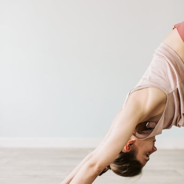 Woman performing a challenging balance yoga pose with focused calm.